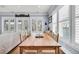 Open concept dining room with hardwood floors, large table, and window with shutter at 1063 Hills Plantation Dr, Charleston, SC 29412