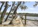 Beautiful wooden dock with scenic water view under a partly cloudy sky at 1063 Hills Plantation Dr, Charleston, SC 29412