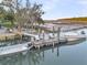 Aerial view of a boat dock and boat lift featuring lounge chairs and a boat secured to the dock at 1063 Hills Plantation Dr, Charleston, SC 29412