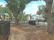 Community dog park with mature trees, bench, and secure fencing at 1063 Hills Plantation Dr, Charleston, SC 29412