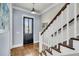 Beautiful entryway featuring hardwood floors, stairs and a stylish black door at 1063 Hills Plantation Dr, Charleston, SC 29412