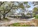 Elegant homes surrounded by lush landscaping and mature trees, offering a picturesque street view at 1063 Hills Plantation Dr, Charleston, SC 29412