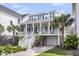 Charming two-story home features a welcoming front porch, white railing, and manicured landscaping at 1063 Hills Plantation Dr, Charleston, SC 29412