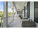 Spacious front porch with cozy seating, ceiling fan, and views of the neighborhood at 1063 Hills Plantation Dr, Charleston, SC 29412