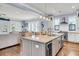 Open-concept kitchen with granite island, stainless steel appliances, and hardwood floors at 1063 Hills Plantation Dr, Charleston, SC 29412