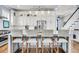 The kitchen features a large island with seating and views into the staircase at 1063 Hills Plantation Dr, Charleston, SC 29412