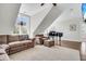Bright living room featuring a grand piano, comfortable seating, and lots of natural light from the tall windows at 1063 Hills Plantation Dr, Charleston, SC 29412