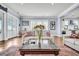 Spacious living room with a view, featuring hardwood floors, a sofa and access to kitchen at 1063 Hills Plantation Dr, Charleston, SC 29412