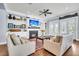 Cozy living room with fireplace, large TV, and views out to the deck at 1063 Hills Plantation Dr, Charleston, SC 29412
