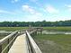 Picturesque boardwalk winding through a lush green marsh landscape and waterfront at 1063 Hills Plantation Dr, Charleston, SC 29412