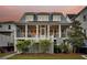 Charming home with a spacious, screened-in porch, white railings, and manicured landscaping at 1063 Hills Plantation Dr, Charleston, SC 29412