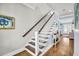 Elegant staircase featuring hardwood steps and white railings at 1063 Hills Plantation Dr, Charleston, SC 29412