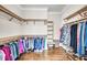 Spacious walk-in closet with custom wood shelving and hardwood floors at 1063 Hills Plantation Dr, Charleston, SC 29412