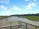 Picturesque waterfront featuring a pier with boats docked along a serene river under a partly cloudy sky at 1063 Hills Plantation Dr, Charleston, SC 29412