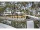 Serene waterfront view with a dock leading to beautiful homes and mature trees at 1063 Hills Plantation Dr, Charleston, SC 29412