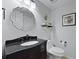 Stylish half-bathroom featuring a decorative mirror and modern fixtures at 108 Smith St # 108-I, Charleston, SC 29403