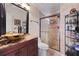 Well-appointed bathroom featuring a granite vanity, vessel sink, and tiled shower with glass door at 108 Smith St # 108-I, Charleston, SC 29403