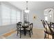 Inviting dining area with a round wooden table set and natural light from a nearby window at 108 Smith St # 108-I, Charleston, SC 29403