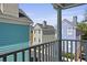 View of colorful multi-story homes from a railed porch with clear blue sky in the background at 108 Smith St # 108-I, Charleston, SC 29403