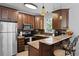 Well-equipped kitchen featuring stainless steel appliances, wood cabinets, and a granite countertop at 108 Smith St # 108-I, Charleston, SC 29403