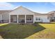 Rear exterior view of home featuring a large screened in patio perfect for entertaining at 110 Haverhill St, Summerville, SC 29486