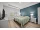 Bright bedroom with ample natural light, a tray ceiling, and soothing blue accent wall at 110 Haverhill St, Summerville, SC 29486