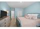 Inviting bedroom with blue walls, shuttered windows, and wood-look flooring at 110 Haverhill St, Summerville, SC 29486