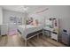Bright bedroom boasts a four-poster bed, white dresser, vanity, and ample natural light through large windows at 110 Haverhill St, Summerville, SC 29486