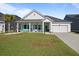 Inviting exterior with a front porch swing, rocking chairs, and a two-car garage at 110 Haverhill St, Summerville, SC 29486