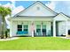 Inviting front porch features a swing, rocking chairs, and well-manicured lawn at 110 Haverhill St, Summerville, SC 29486
