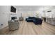 Inviting living room with a plush blue sectional, fireplace, and views of the dining area and kitchen at 110 Haverhill St, Summerville, SC 29486