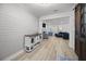 Open-concept living room featuring shiplap walls, stylish console, hardwood floors and seamless flow into the dining area at 110 Haverhill St, Summerville, SC 29486