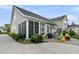Home exterior with screened porch, outdoor seating area, and manicured landscaping at 113 Sugarberry Way, Summerville, SC 29485