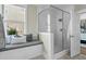 Bright bathroom features tiled shower, glass door and window seat with storage at 113 Sugarberry Way, Summerville, SC 29485