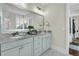 Bright bathroom with double sinks, framed mirror and updated lighting at 113 Sugarberry Way, Summerville, SC 29485