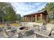 Inviting outdoor area featuring brick structure, fire pit, and wooden Adirondack chairs at 113 Sugarberry Way, Summerville, SC 29485