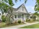 Beautifully landscaped home exterior with inviting front porch and meticulous yard at 113 Sugarberry Way, Summerville, SC 29485