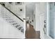 Elegant foyer featuring hardwood floors, staircase with crisp white railing, and stylish decor at 113 Sugarberry Way, Summerville, SC 29485