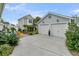 A spacious two-car garage with ample driveway space and charming landscaping at 113 Sugarberry Way, Summerville, SC 29485