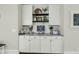 Kitchenette featuring modern white cabinets, granite countertops, and decorative shelves at 113 Sugarberry Way, Summerville, SC 29485