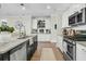 Bright kitchen featuring stainless steel appliances, black island, white cabinets, and pendant lighting at 113 Sugarberry Way, Summerville, SC 29485