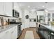 Modern kitchen featuring stainless appliances, white cabinets, granite countertops, and hardwood floors at 113 Sugarberry Way, Summerville, SC 29485