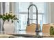 Close-up of kitchen island featuring modern faucet, marble countertops, and stylish decor at 113 Sugarberry Way, Summerville, SC 29485