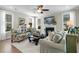Cozy living room features a fireplace, ceiling fan, large windows, and plush seating at 113 Sugarberry Way, Summerville, SC 29485