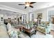 Bright open-concept living room with adjacent dining room, large windows, and comfortable seating at 113 Sugarberry Way, Summerville, SC 29485