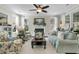 Inviting living room with fireplace, ceiling fan, large windows, and comfortable seating at 113 Sugarberry Way, Summerville, SC 29485