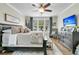 Well lit main bedroom with beautiful floors, ceiling fan, mounted television and a comfortable seating area at 113 Sugarberry Way, Summerville, SC 29485