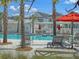 Relaxing poolside view featuring lounge chairs, palm trees, and clear blue water at 113 Sugarberry Way, Summerville, SC 29485