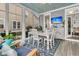 Bright sunroom with lots of windows and a stylish dining set perfect for relaxing or entertaining at 113 Sugarberry Way, Summerville, SC 29485