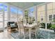 Charming sunroom with a bright dining set and a decorative rug, full of natural light at 113 Sugarberry Way, Summerville, SC 29485